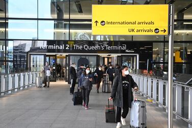 Travellers at the international arrival hall of Heathrow Airport. EPA