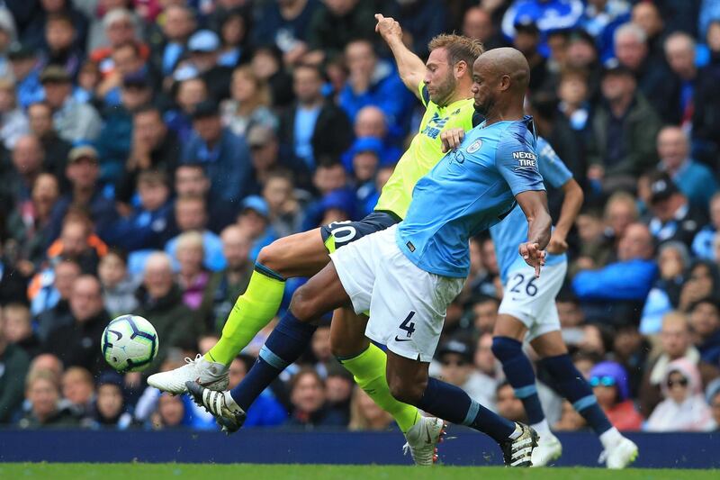 Manchester City's Belgian defender Vincent Kompany (R) tackles Huddersfield Town's Belgian striker Laurent Depoitre (L) during the English Premier League football match between Manchester City and Huddersfield Town at the Etihad Stadium in Manchester, north west England, on August 19, 2018. (Photo by Lindsey PARNABY / AFP) / RESTRICTED TO EDITORIAL USE. No use with unauthorized audio, video, data, fixture lists, club/league logos or 'live' services. Online in-match use limited to 120 images. An additional 40 images may be used in extra time. No video emulation. Social media in-match use limited to 120 images. An additional 40 images may be used in extra time. No use in betting publications, games or single club/league/player publications. / 