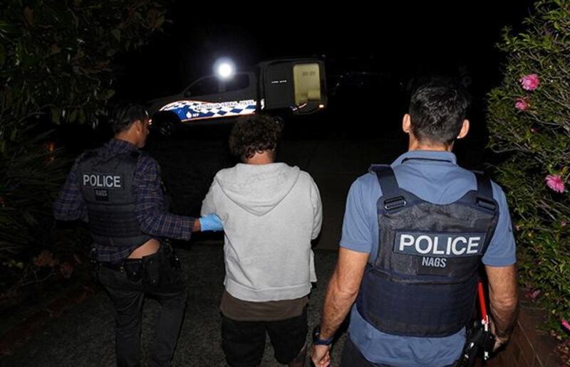 A person is detained by Australian Federal Police after its Operation Ironside against organised crime in this undated handout photo released June 8, 2021.   Australian Federal Police/Handout via REUTERS   ATTENTION EDITORS - THIS IMAGE HAS BEEN SUPPLIED BY A THIRD PARTY. MANDATORY CREDIT. MUST CREDIT “AUSTRALIAN FEDERAL POLICE”. NO RESALES. NO ARCHIVES.