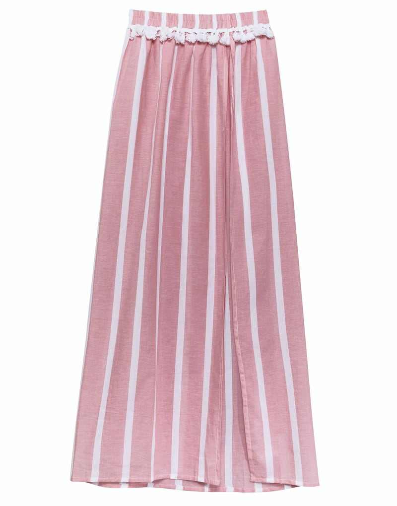 <p>Everyone needs a lightweight skirt on holiday, and we love this striped pom-pom number;&nbsp;Dh218,&nbsp;Asos&nbsp;</p>
