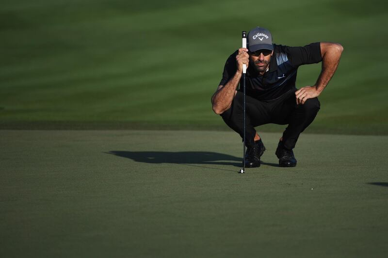 Alvaro Quiros of Spain lines up a putt on the second green. Ross Kinnaird / Getty Images