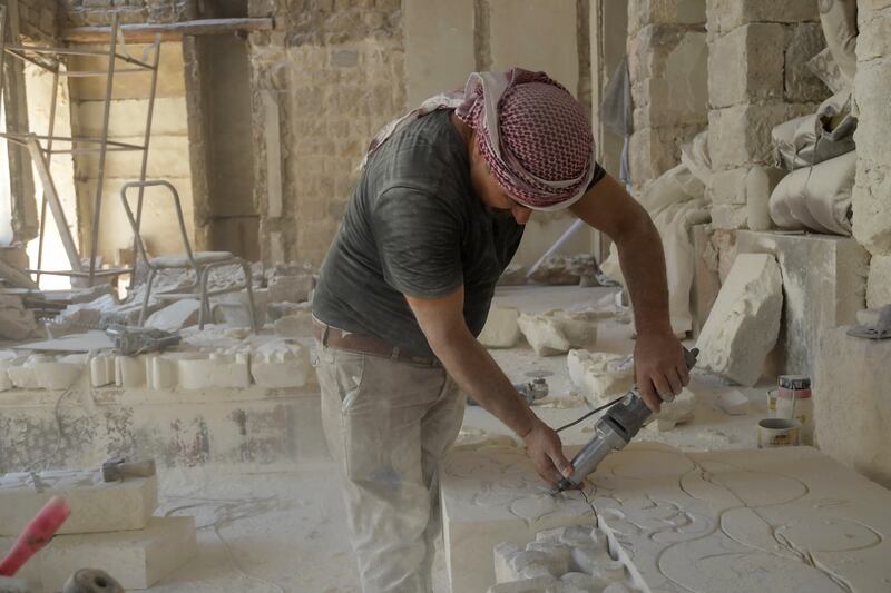 A labourer works on the renovation of the Beit Ghazaleh house, an Ottoman-era-built residence in the Jdaydeh area of Aleppo's old town in northern Syria.