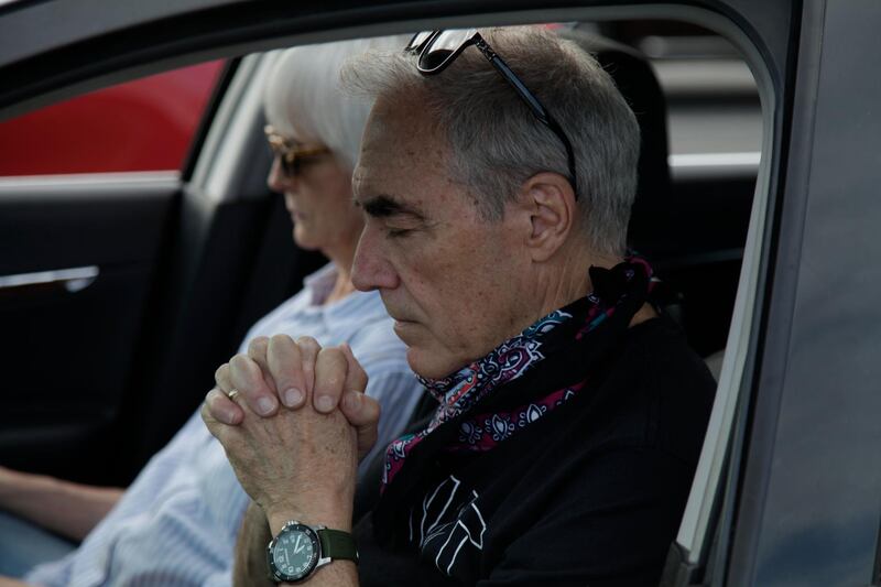 Terry Sartain prays inside his car during Relevant Church's Easter service at a YMCA parking lot in Clover, South Carolina. AP Photo