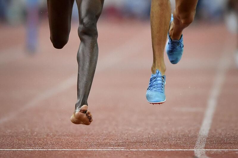 Kenya's Conseslus Kipruto, left, who lost his shoe during the race, wins the men's 3000 meters steeplechase, ahead of second placed Morocco's Soufiane El Bakkali, right, during the IAAF Diamond League athletics meeting Weltklasse in Zurich. AFP