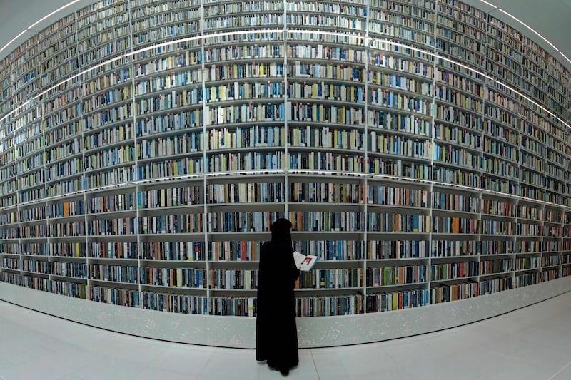 A visitor checks a book at the Mohammed Bin Rashid Library. AFP
