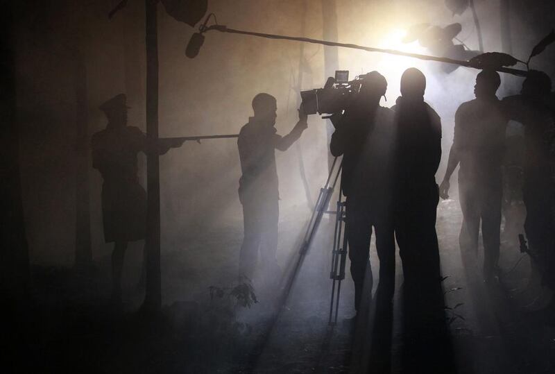 Actors perform a scene at night while filming ‘October 1’, a police thriller directed by Kunle Afolayan, in Akure, Nigeria.