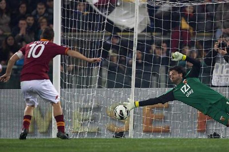 Roma captain Francesco Totti fires home from the penalty spot against Genoa to become Italy's joint second-top goalscorer.