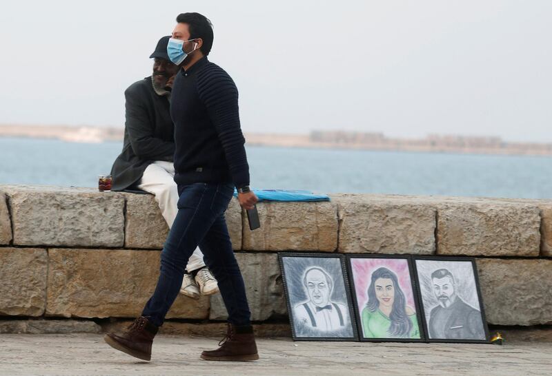 A man walks in front of a street painting vendor amid the coronavirus disease pandemic in the Mediterranean city of Alexandria, north of Cairo, Egypt. Reuters