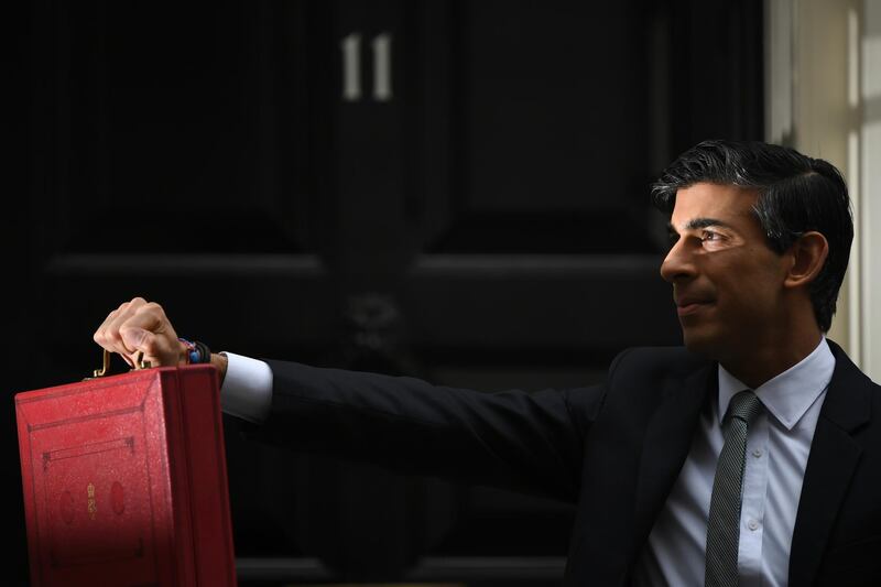 Rishi Sunak didplays the budget box to the waiting media. Getty Images