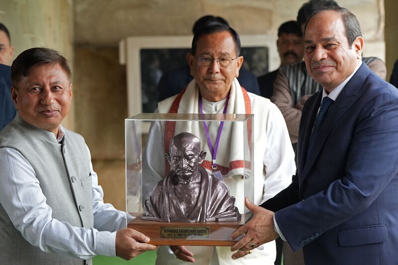Egypt’s President Abdel Fattah El Sisi, right, receives a bust of Mahatma Gandhi at his memorial in New Delhi. AFP
