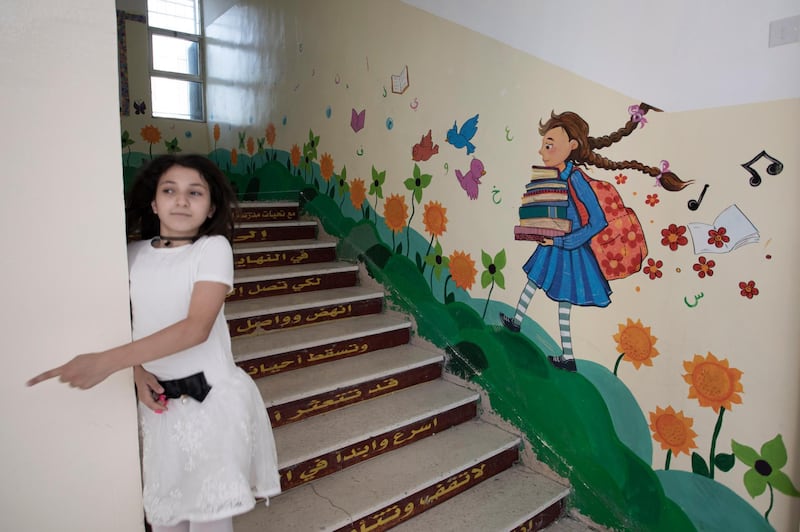 A Student walks down the stairs, at Nuzha Girls School, in Amman, Jordan.  EPA