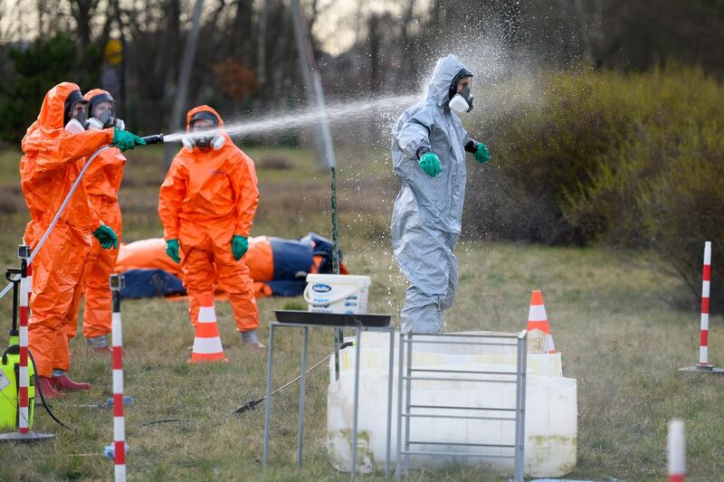 Firefighters dealing with a Covid-19 infestation decontaminate themselves in Poznan,, Poland. EPA