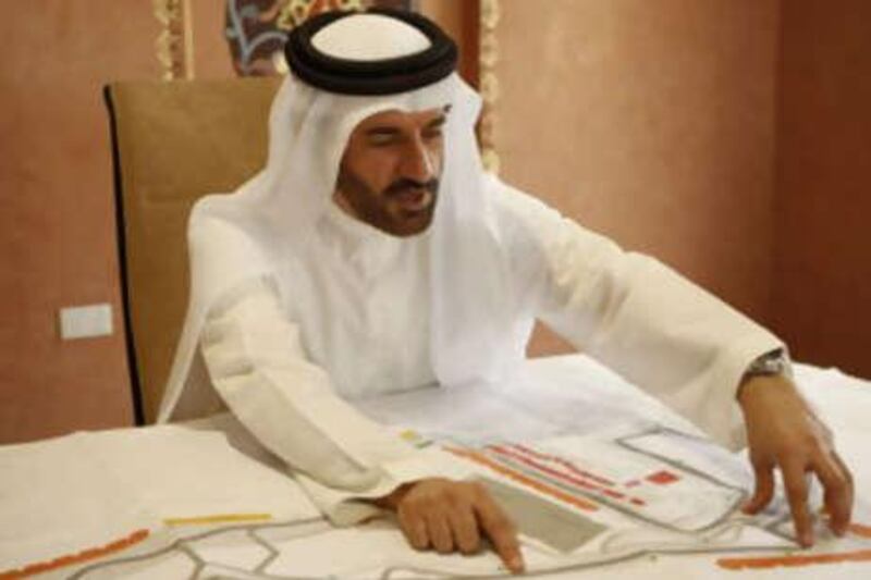 The newly appointed member of the World Motorsport Council, Mohammed Ben Sulayem looks over a map of the new Formula One Race Track that is being built in Abu Dhabi in this file photo from Oct 16 2008.