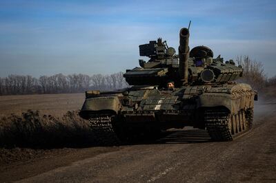 A Ukrainian tank drives down a road near Bakhmut in the Donetsk region.  AFP