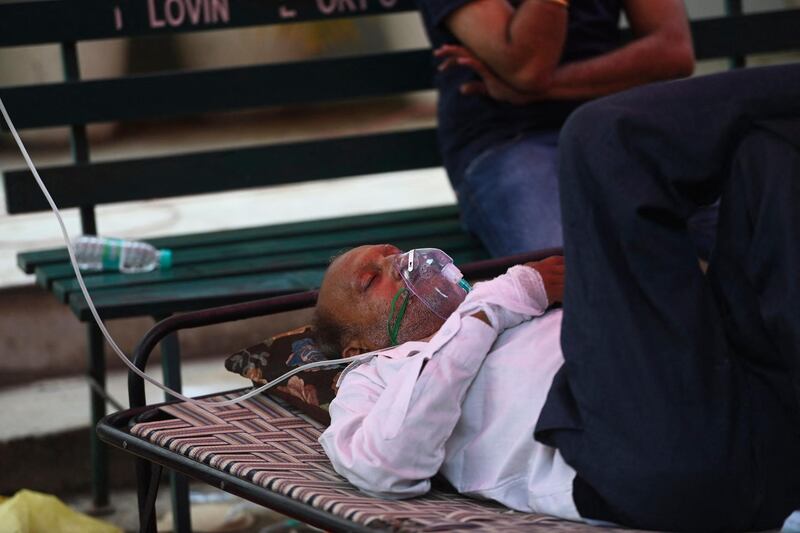A patient breathes with the help of oxygen provided at a Sikh temple in Ghaziabad. AFP