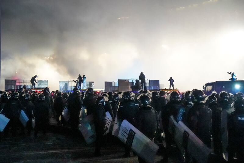 Riot police block protesters in the center of Almaty, Kazakhstan. AP