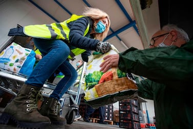 Volunteers carry food packages to distribute to charitable organisations at the food bank in Palma de Mallorca. Strongly impacted by the covid-19 pandemic, Spain registered an increase of more than 25,000 unemployed in November, the worst figure in this month for eight years. AFP