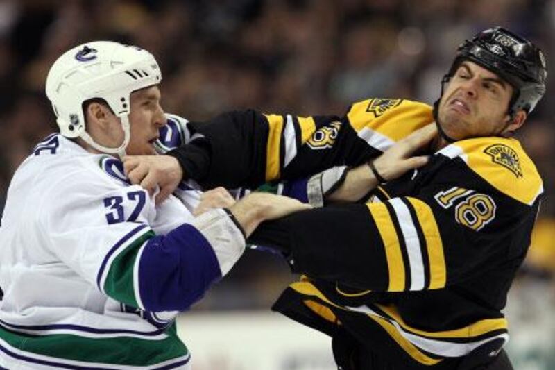Fighting is down this year in the NHL, but Toronto general manage Brian Burke says that could be a problem and that he notices players are doing less policing of themselves, such as Nathan Horton, right, getting into a fight with Vancouver's Dale Weise in early January, which was a bit of payback for Vancouver knocking Horton out of the Stanley Cup finals with a concussion.