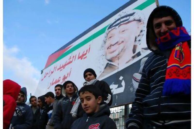Home supporters in the stands beneath a giant poster of Yasser Arafat, the late Palestine leader.