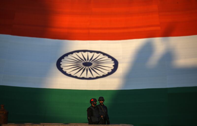 Indian Navy marine commandos stands in front of the Indian national flag,  measuring 225 feet in length and 150 feet in width, making it as the world's largest national flag, which has been exhibited during Navy Day celebrations in Mumbai, India, 04 December 2021.  The Indian Navy celebrates Navy Day 04 December to commemorate the Indian Navy attack on Karachi harbour during the Indo-Pakistan war in 1971.   EPA / DIVYAKANT SOLANKI