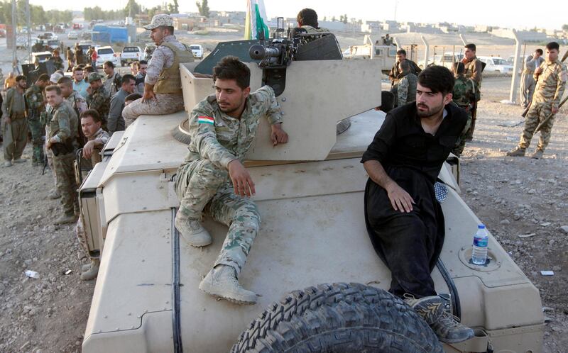 Kurdish Peshmerga fighters sit on a military vehicle north of Kirkuk, Iraq October 19, 2017. REUTERS/Ako Rasheed