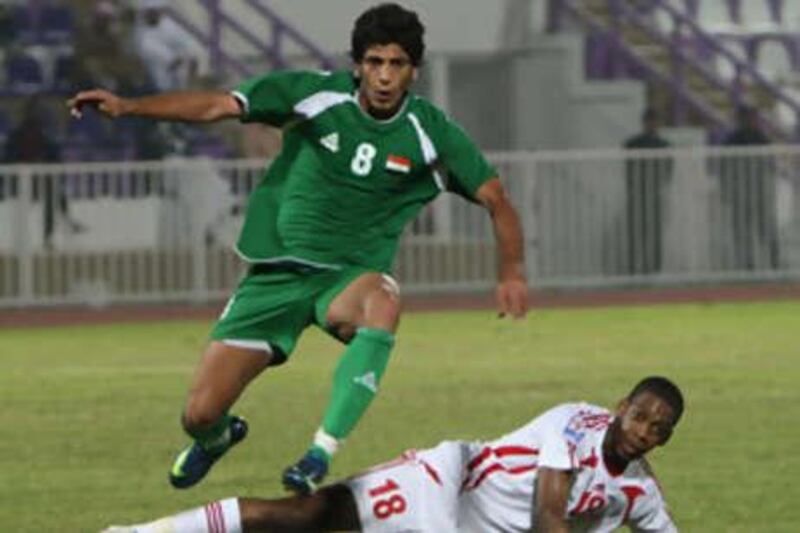 The UAE's Abdullah Mal Allah tangles with Iraq's Mohammed Nasir during the second half.