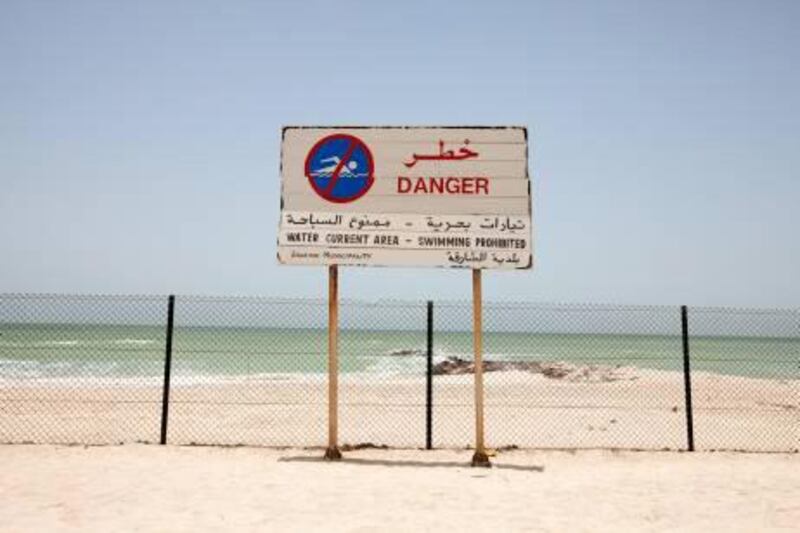 New barriers, such as in Al Rifah area near Ajman, prevent swimmers reaching the water after it was ruled too dangerous. Jaime Puebla / The National