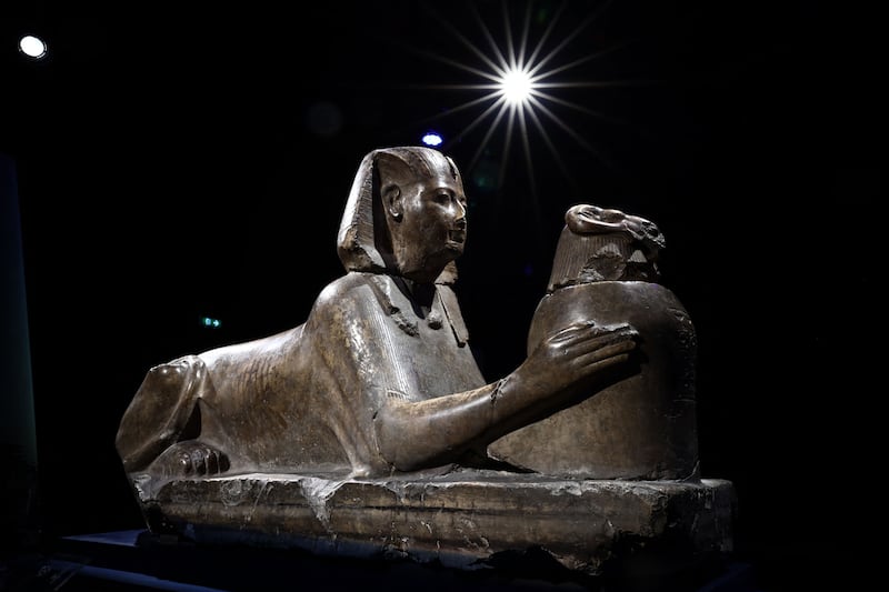 A statue featuring Pharaoh Ramses II as a Sphinx offering a ram-headed vessel. AFP