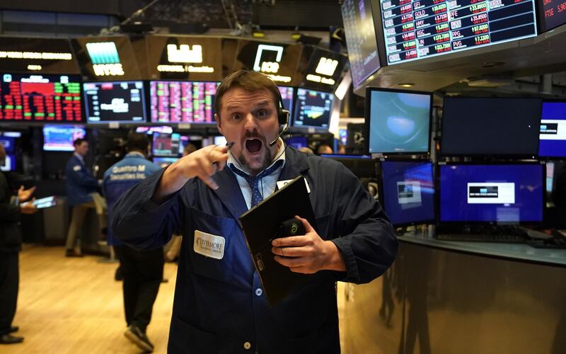 Traders work during the closing bell at the New York Stock Exchange (NYSE) on Wall Street in New York City.  AFP