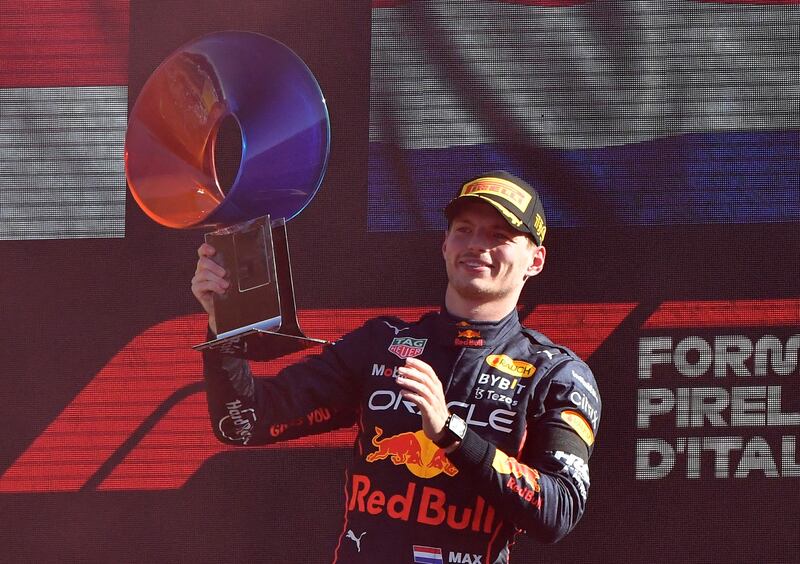 Red Bull's Max Verstappen celebrates with the trophy on the podium after winning the Italian Grand Prix in Monza on September 11, 2022. Reuters