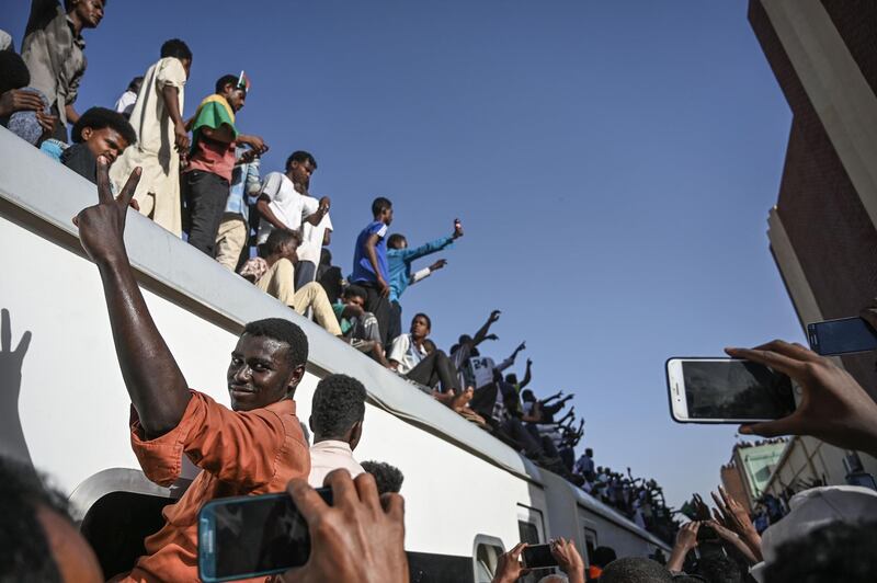 Sudanese protesters from the city of Atbara, sitting atop a train, flash the V-sign of victory as they arrive at the Bahari station in Khartoum.  The passengers, who had travelled from the town of Atbara where the first protest against ousted president Omar al-Bashir erupted on December 19, chanted "freedom, peace, justice". AFP