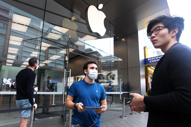 SYDNEY, AUSTRALIA - MAY 07: SYDNEY, AUSTRALIA - MAY 07: A staff member assists a customer prior to entering the Bondi Junction Apple Store on May 07, 2020 in Sydney, Australia. Apple stores across Australia reopened today, after closing temporarily in response to the COVID-19 outbreak. Additional safety procedures have been implemented to ensure customer and staff safety, including temperature checks, social distancing measures and limiting the number of visitors in the store at one time. (Photo by Lisa Maree Williams/Getty Images)