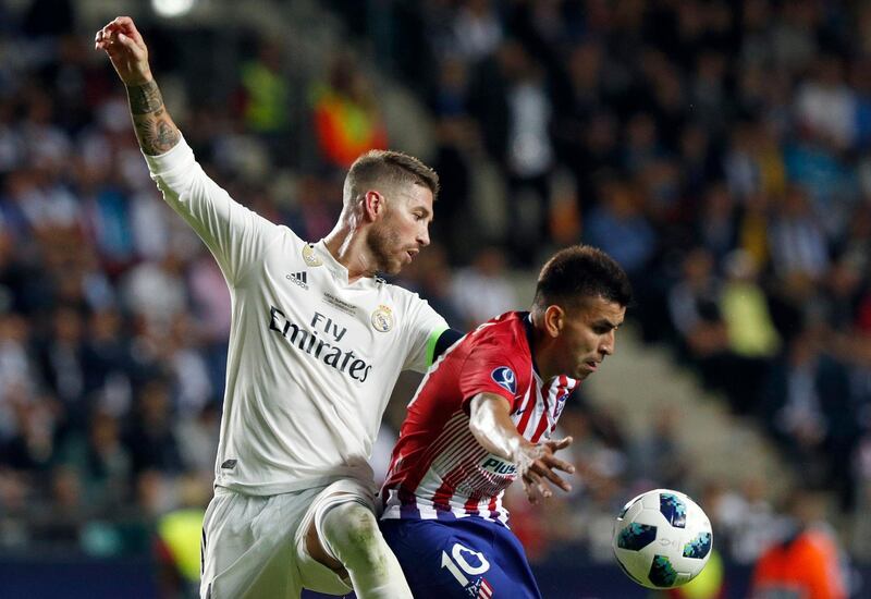 Ramos and Atletico's Angel Correa challenge for the ball. AP