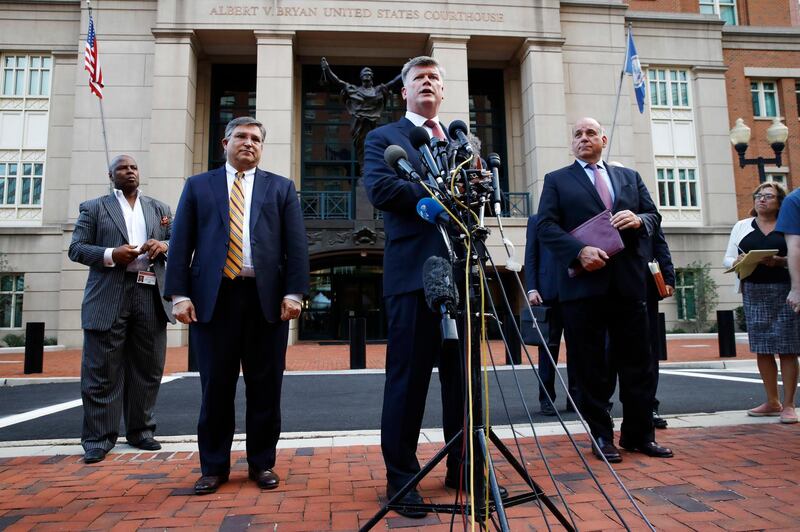 Kevin Downing, center, with Richard Westling, left, and Thomas Zehnle, right, with the defense team for Paul Manafort, speaks to the media outside of federal court after the third day of jury deliberations in the trial of the former Donald Trump campaign chairman, in Alexandria, Va., Monday, Aug. 20, 2018. (AP Photo/Jacquelyn Martin)