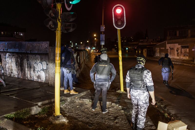 Undercover and uniformed Saps members and security officers brace themselves, as violence and looting continued after a weekend of disorder involving pro-Zuma protesters.