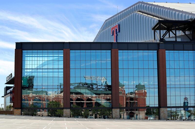 The image of the Texas Rangers baseball club's old stadium, Globe Life Park, is reflected on the exterior wall of the club's newly constructed home, Globe Life Field, in Arlington, Texas. AP Photo