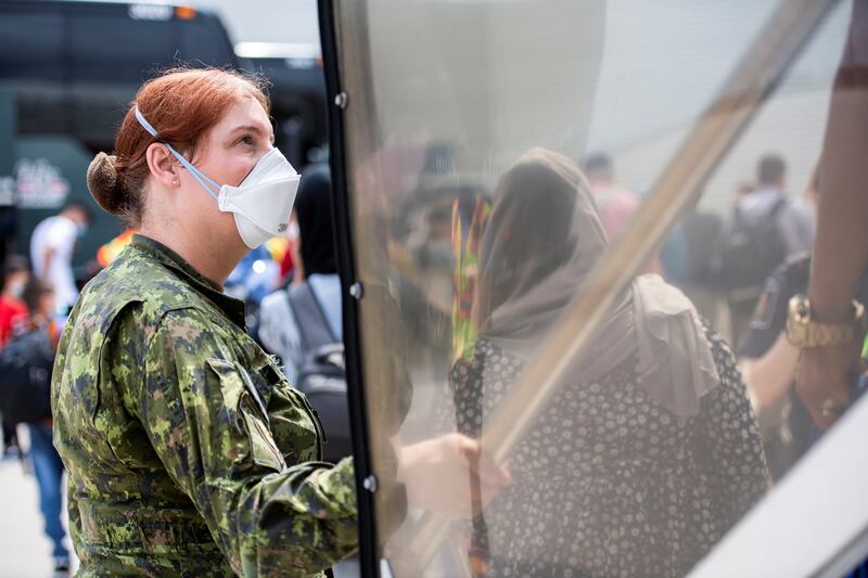 A Canadian Armed Forces medic assists Afghan refugees at Toronto Pearson International Airport. Photo: Canadian Forces Combat Camera/Handout via Reuters