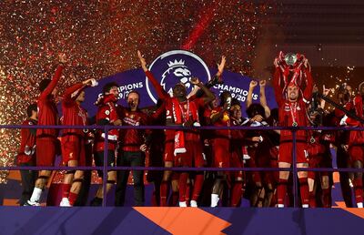 LIVERPOOL, ENGLAND - JULY 22: Jordan Henderson of Liverpool lifts The Premier League trophy following the Premier League match between Liverpool FC and Chelsea FC at Anfield on July 22, 2020 in Liverpool, England. Football Stadiums around Europe remain empty due to the Coronavirus Pandemic as Government social distancing laws prohibit fans inside venues resulting in all fixtures being played behind closed doors. (Photo by Laurence Griffiths/Getty Images)