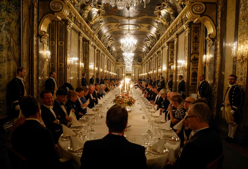 Guests attend a state dinner for French President Emmanuel Macron at the Royal Palace in Stockholm, Sweden. AFP