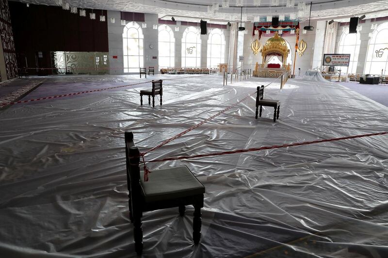 DUBAI, UNITED ARAB EMIRATES , June 30 – 2020 :- Inside view of the main prayer hall and floor covered with plastic sheets as a preventive measure against the spread of the coronavirus at the Gurunanak Darbar in Jebel Ali in Dubai. Places of worship opening up tomorrow in the UAE. (Pawan Singh / The National) For News. Story by Ramola