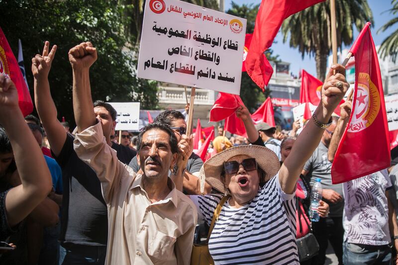 Supporters of the Tunisian General Labour Union (UGTT) rally outside its headquarters in Tunis before a nationwide public sector strike in June. AP
