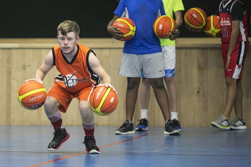 Vincent Baur-Richter, a 20-year-old with Down syndrome, plays with his basketball team. His father was surprised to find sports clubs in Abu Dhabi were happy to have Vincent on their team. Mona Al Marzooqi / The National 