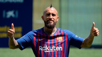 Arturo Vidal poses during his official presentation at the Camp Nou in Barcelona. AFP