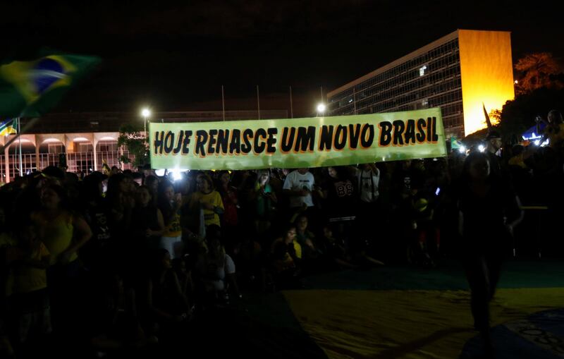 A sign held aloft by Bolsonaro supporters reads: 'Today a new Brazil is reborn'. REUTERS