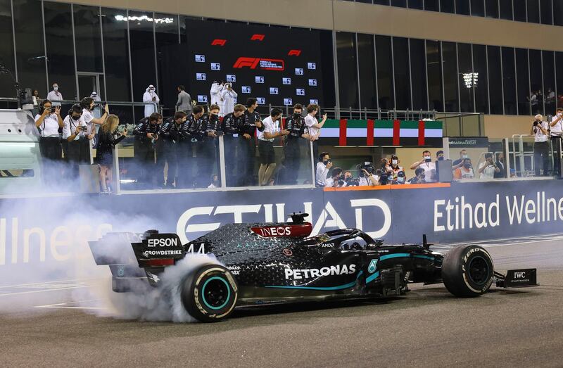 Mercedes driver Lewis Hamilton burns tires after the race. AP
