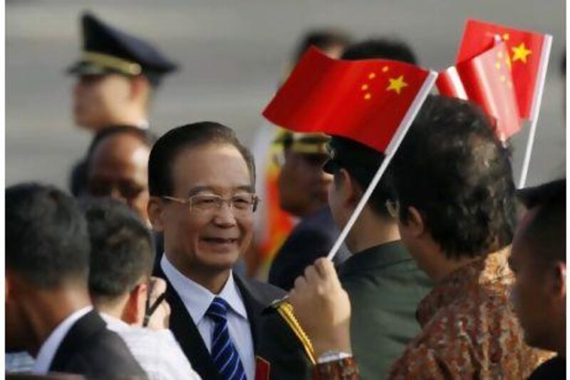 Chinese Premier Wen Jiabao smiles as he arrives for the Association of South East Asian Nations (Asean) Summit in Bali on Thursday. Indonesia is hosting the 19th Asean Summit and a related summit.