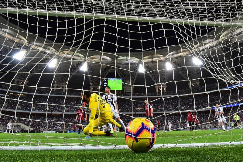 AC Milan's Italian goalkeeper Gianluigi Donnarumma is beaten by Ronaldo's effort for the only goal of the game. AFP