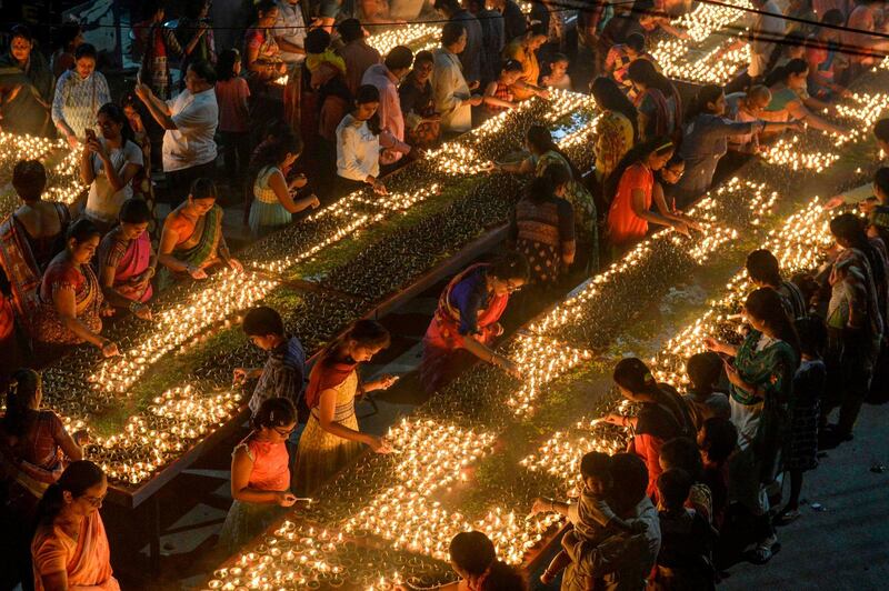 Devotees perform a ritual by lighting diyas (earthen lamps) on the occasion of Karthika or Kartik month in Hyderabad. AFP