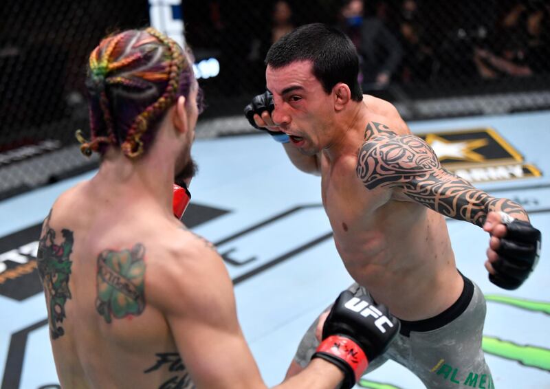 Thomas Almeida of Brazil punches Sean O'Malley in their bantamweight fight during the UFC 260 event at UFC APEX in Las Vegas, Nevada. Jeff Bottari / USA TODAY Sports / Reuters