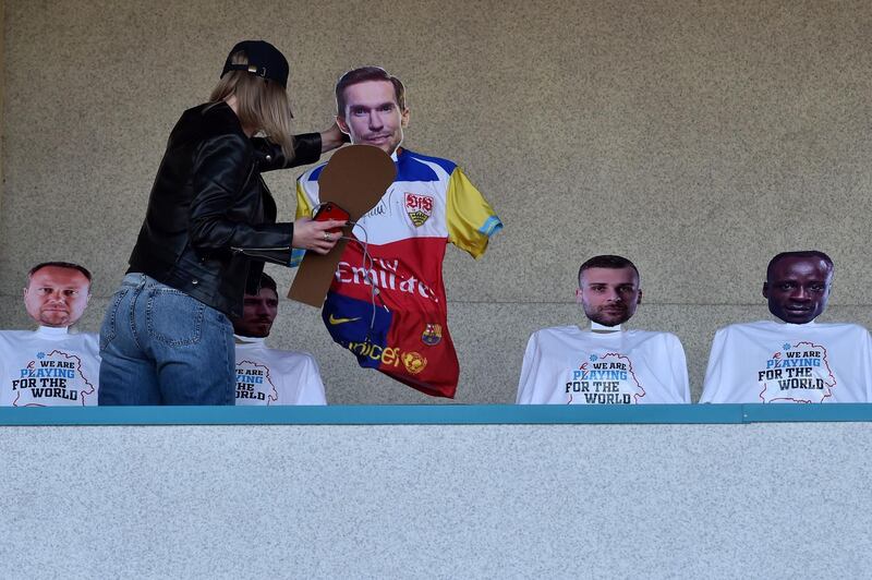 A woman installs dummies to mimic audience during the match between Dynamo Brest and FC Isloch. AFP